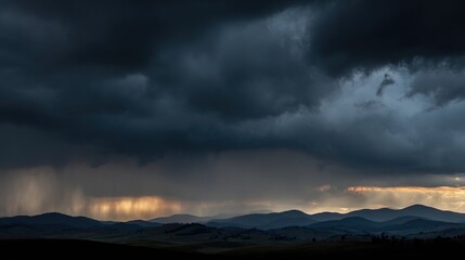 Obraz premium Storm clouds and distant rainfall over layered mountain landscape at dusk