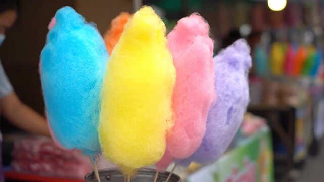 Colorful cotton candy in a row at an outdoor event or fair