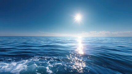 Obraz premium The sun is shining on the ocean, creating a beautiful and serene scene. The water is calm and the sky is clear, making for a perfect day to be out on the water