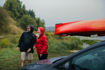 Senior couple enjoying rainy kayaking adventure