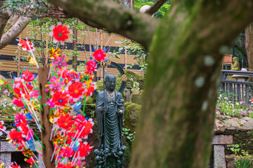 Jizo Bosatsu Buddha statue with flower toy of Nanzoin temple, Fukuoka