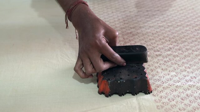 Hand Block Printing: Dipping Stamp in Color and Pressing on Fabric 