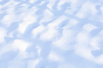 Winter snow waves. Snow texture. Play of light and shadow. Snow-white texture for design. Snowflakes
