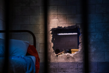 Prison break by wrecking wall by hammer. Escape and flee concept