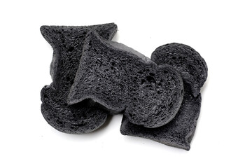 Black charcoal bread slices on white background