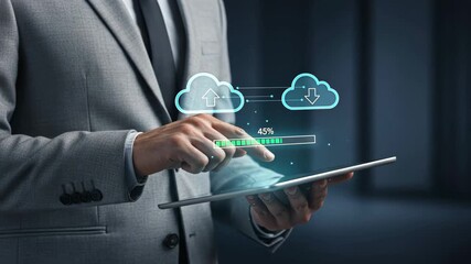 Businessman using tablet with holographic upload download clouds and progress bar, futuristic cloud network and data security - Powered by Adobe