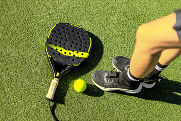 Woman Padel tennis player with racket in action on the court. Girl athlete with paddle racket on court outdoors. Sport concept.