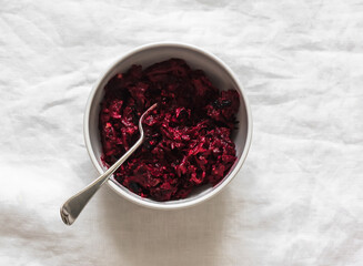 Beetroot salad with walnuts, prunes and greek yogurt - a delicious snack, tapas, appetizers on a light background, top view