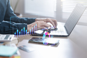 Hands typing on a laptop with digital charts, bar graphs, and analytic overlays, representing data analysis, business insights, and performance monitoring in a modern digital workspace. Analysis