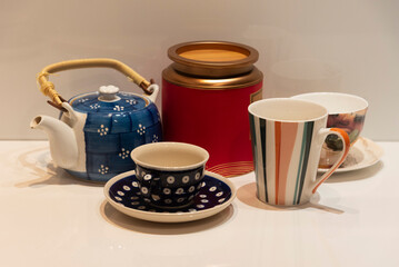 Kitchen utensils on the table arranged on a reflective white surface.
