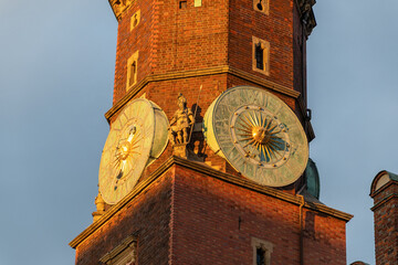 Renaissance clock tower with astronomical dials at sunset. The Old Town Hall in wroclaw