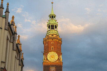 Historic clock tower at sunrise with dramatic sky backdrop. The Old Town Hall in wroclaw