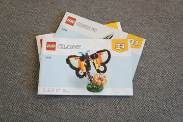 Obraz premium Lego Creator 3-in-1 Butterfly Instruction Manuals on a Gray Surface