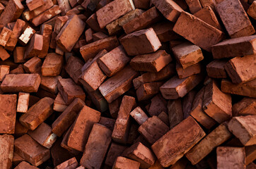 Pile of Red Bricks Stacked for Construction Projects Creating Textured Background