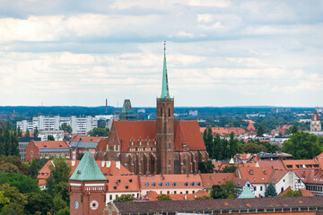 Fototapeta premium Aerial view of historic red brick cathedral in wroclaw, poland surrounded by cityscape