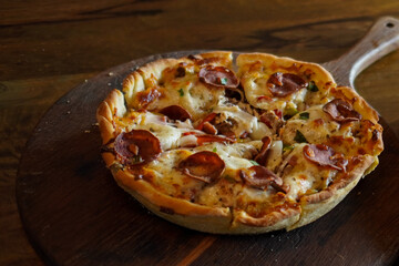 Close-up rustic pepperoni pizza with melted cheese on a wooden board. Warm lighting, appetizing food texture, perfect for menus, restaurant branding, food blogs, and delivery promotions