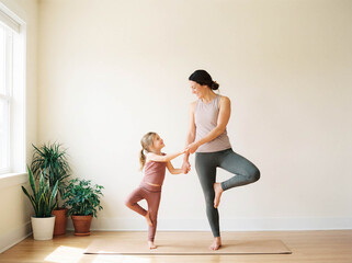 Mother daughter yoga exercise floor copy space fitness healthy lifestyle family workout home mom child stretching sport wellness togetherness activity indoors mat training body care parenting fun