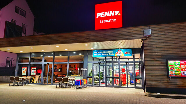 ISERLOHN, GERMANY &mdash; DECEMBER 06 2025: illuminated Penny store sign glowing at night in Letmathe district today
