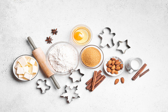 Christmas baking background with baking ingredients and cookie cutters - Powered by Adobe