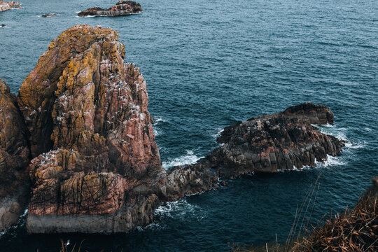 Dramatic ocean seascape with rugged rocky cliffs and crashing waves - Powered by Adobe