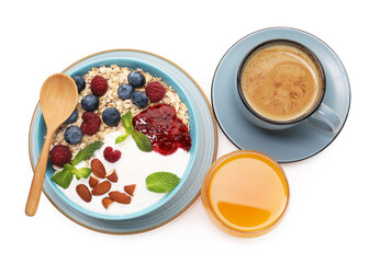 Healthy breakfast. Oatmeal with nuts, berries, yoghurt, jam, coffee and juice isolated on white, top view