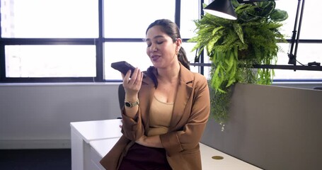 woman picking smartphone on window bench smiling and speaking - Powered by Adobe