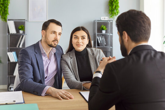 Professional agent, lawyer financial advisor consulting happy family couple clients in office, customers meeting discussing agreement or deal, planning, support negotiation, considering contract - Powered by Adobe