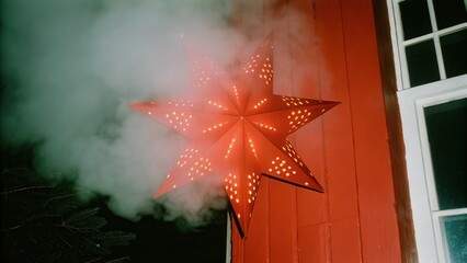 Dark Chirstmas Red star decoration against a wall with smoke effect.