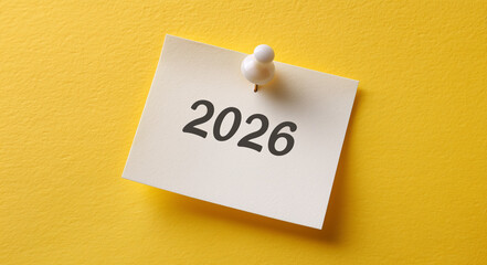 Planning for the future calendar year 2026 reminder note in bright yellow office setting