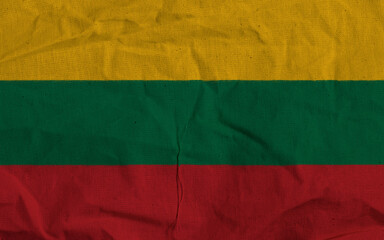 Fototapeta premium Lithuania National Flag With Yellow, Green, And Red Stripes On Textile Surface