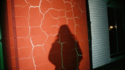 Dark Chirstmas Cracked wall with shadows in a night setting.