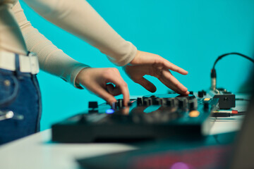 DJ setup overview, Energetic club DJ performing with digital controller in action, Content creator mixing music live using digital turntables under vibrant stage lights