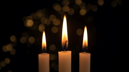Three Lit Candles with Warm Bokeh Lights on a Dark Background