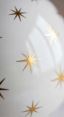 Obraz premium White surface with golden star patterns, creating a festive and decorative background.
