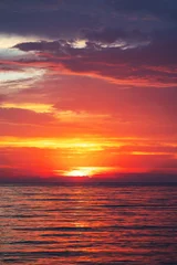 Fotobehang Crimson Beautiful cloudscape over the sea waves scenic sunrise seascape vertical landscape  © ValentinValkov