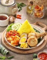 Nasi Kuning. Yellow rice is a typical Indonesian food. This food is made from rice cooked with...