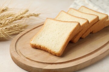 Slices of toast bread on beige table, closeup