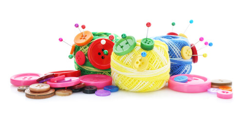 Balls of bright knitting yarn with buttons and pins isolated on white