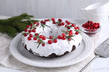 Tasty Christmas cake with cranberries and rosemary on table, closeup