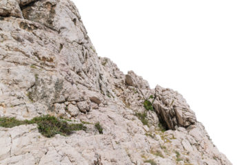 Rocky cliff with sparse vegetation. Isolated object.