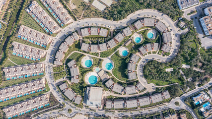 The layout of resort buildings and swimming pools in Salgados, Albufeira, Algarve during daytime, showcasing the design from above