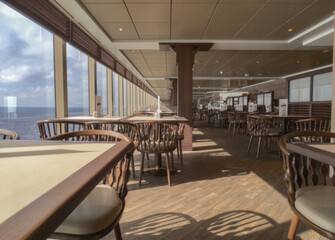 Glasses and wine bottles in casual buffet self-service restaurant onboard luxury cruise ship cruiseship liner	