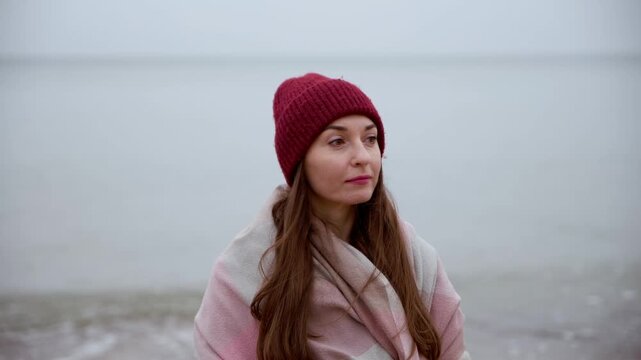 Baltic Sea portrait of woman in red beanie with soft overcast lighting