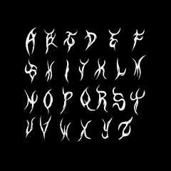 Tribal alphabet with sharp, flame-like letters in a dark metal aesthetic.
