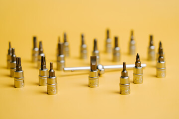 Tools are arranged in a circular pattern on a yellow background with a center tool present