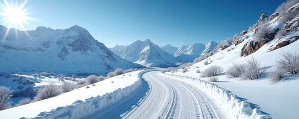 Winding snow covered mountain road under bright sun and clear blue sky. White snowdrifts line the pathway through the wintery landscape, showcasing a serene natural terrain during daytime.