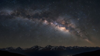 Stunning view of the bright milky way galaxy arching over a dark mountain range silhouette under a clear night sky
