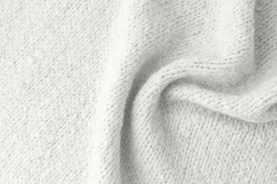 Light grey alpaca an cashmere wool mix texture as background with copy space. Trendy color 20246 year Cloud Dancer backdrop.