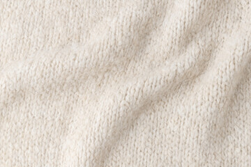 Light beige alpaca wool mix texture as background with copy space. Detail of coarse knit knitting product.