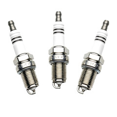 Three New Automotive Spark Plugs with Ceramic and Metal Components isolated on a transparent background